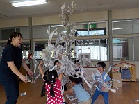 新聞紙で遊ぶ子どもたち