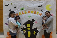 ハロウィンの壁面をバックに記念撮影