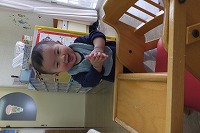 立って手をたたきながら微笑む男の子