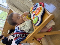 食事用イスに座る練習をする赤ちゃん