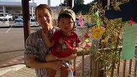 笹飾りの前で笑顔のお母さんと男の子